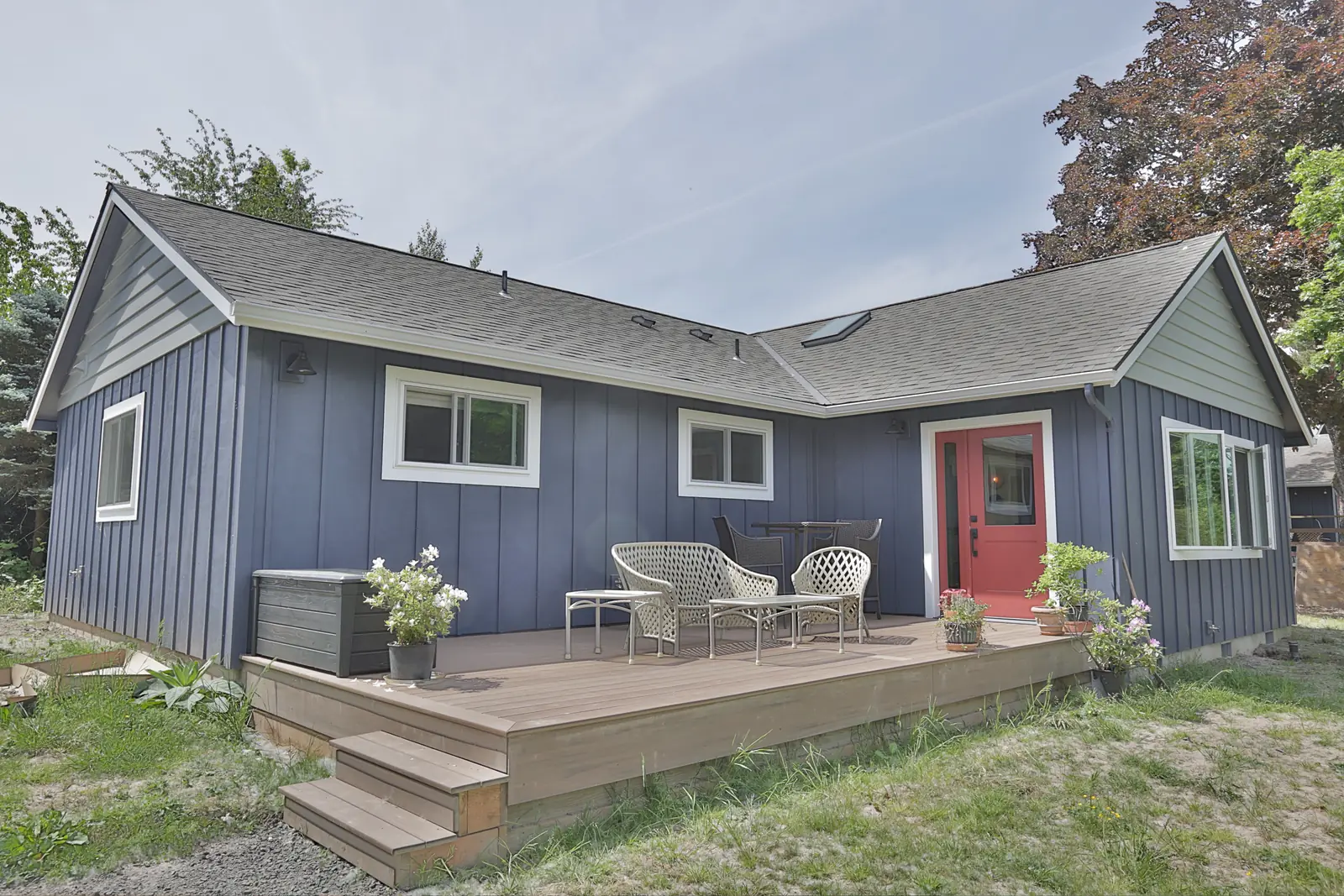 Attached ADU addition near Oregon City, OR — board-and-batten siding and a TimberTech English Walnut PVC deck
