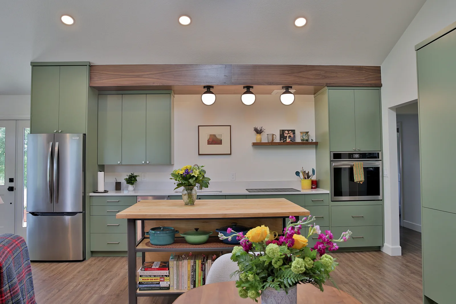 Full ADU kitchen with butcher block island, induction cooktop and wall oven column