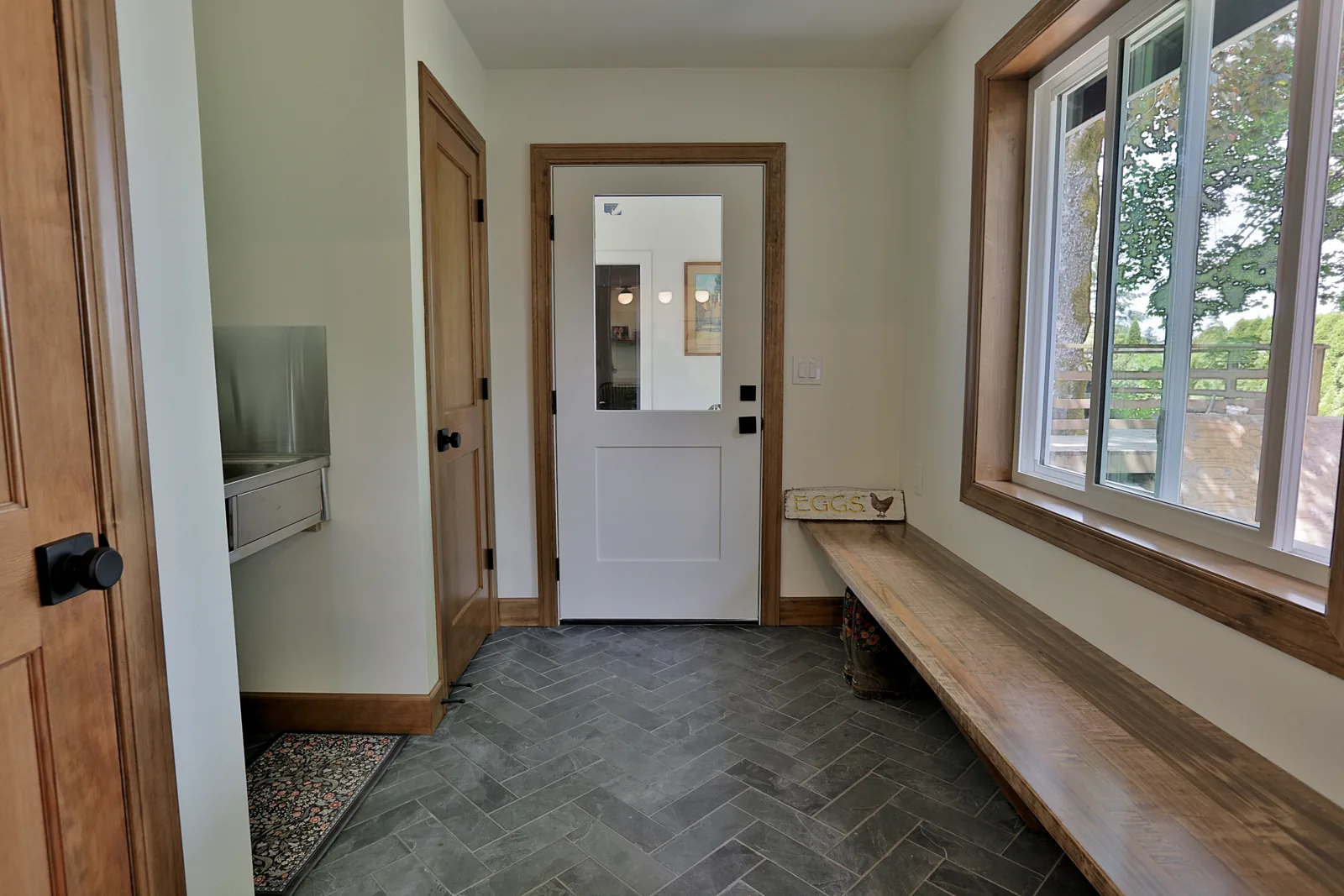 Entry and mudroom with slate herringbone tile floor and utility sink