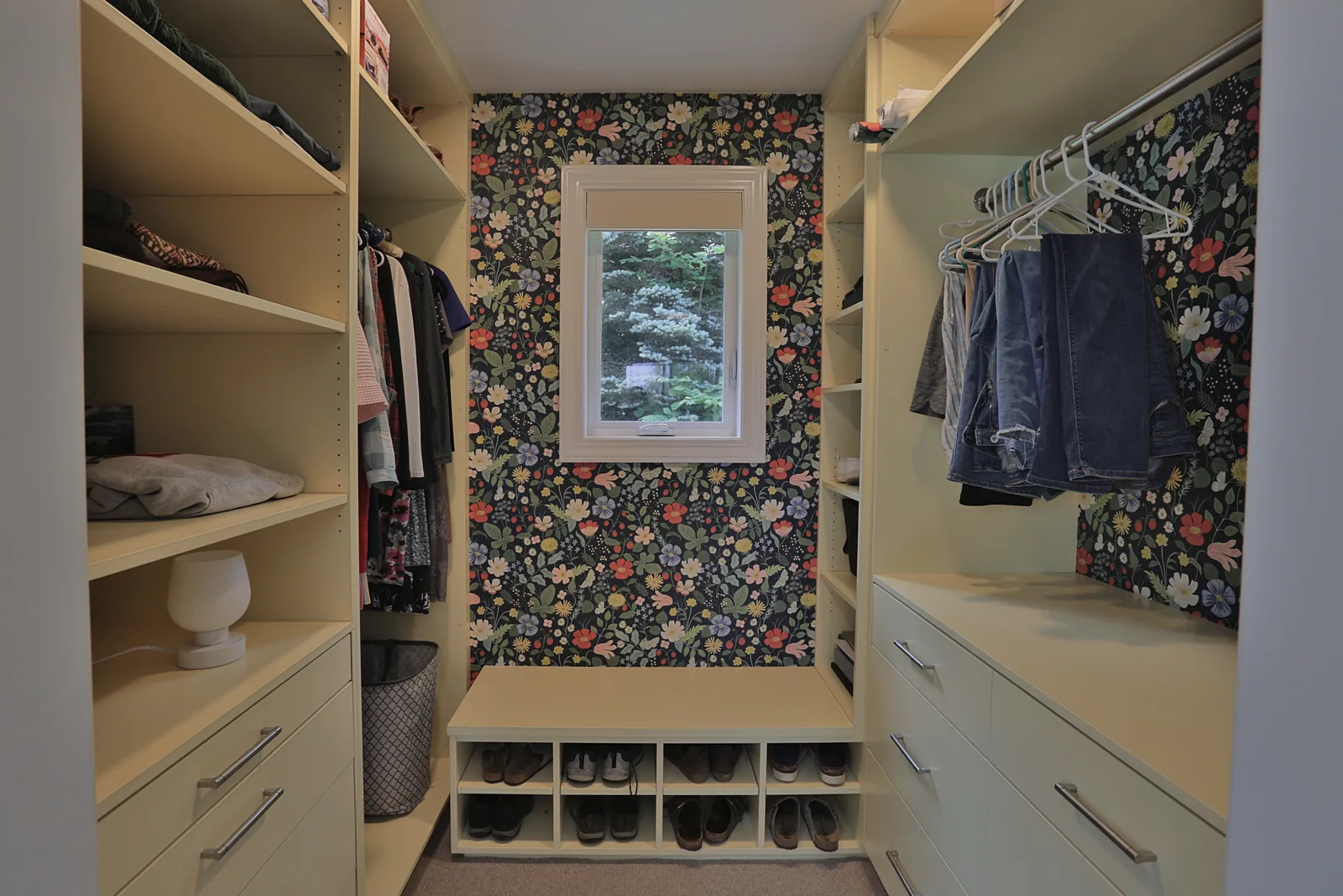 Walk-in closet with custom built-ins, bench seat and shoe storage