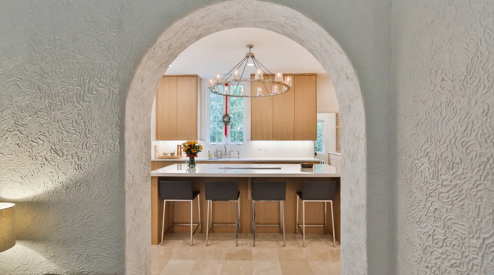 Original arched plaster opening framing the new kitchen in a Portland West Hills historic remodel