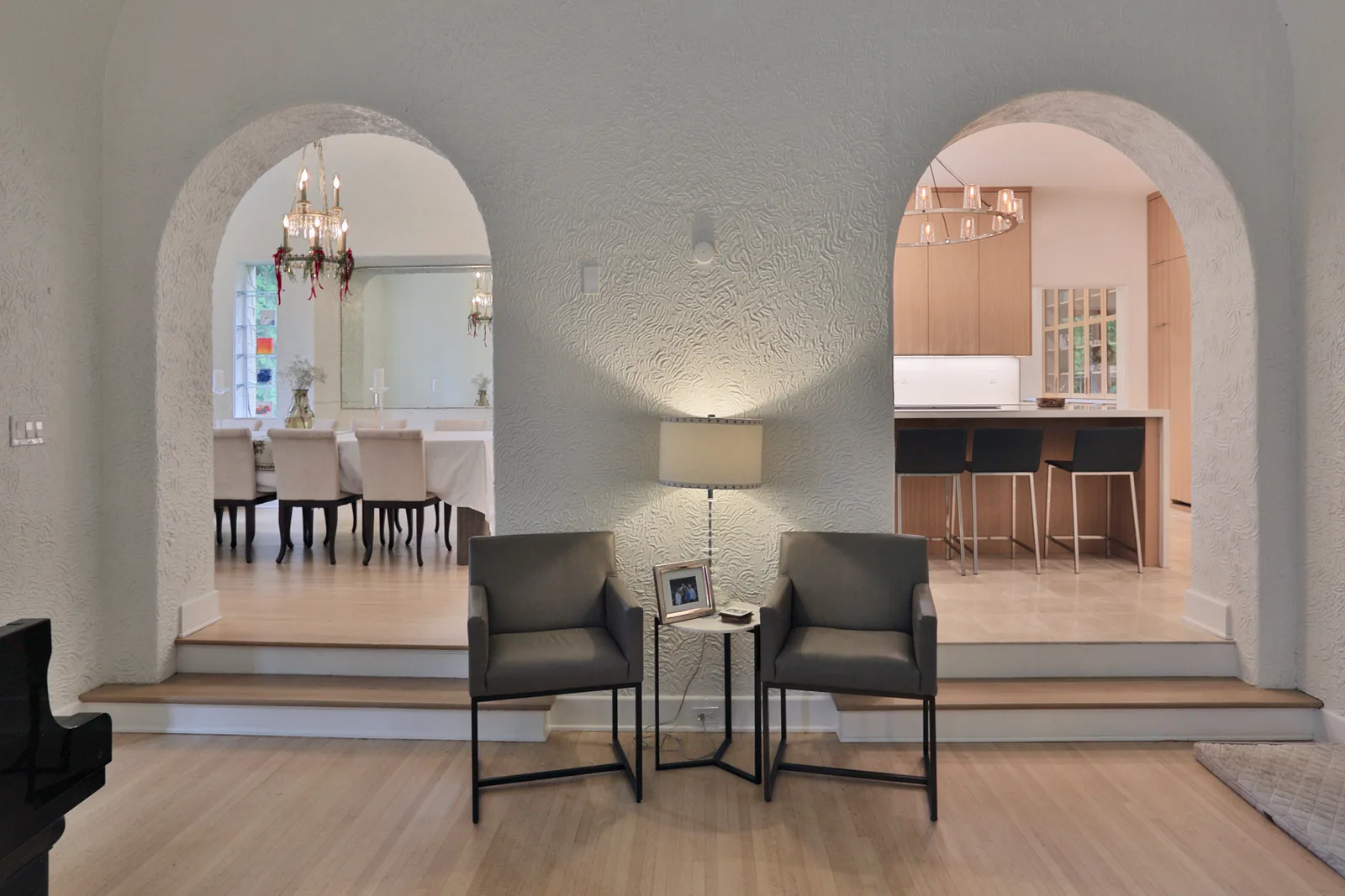 Living room with original textured plaster and arched openings