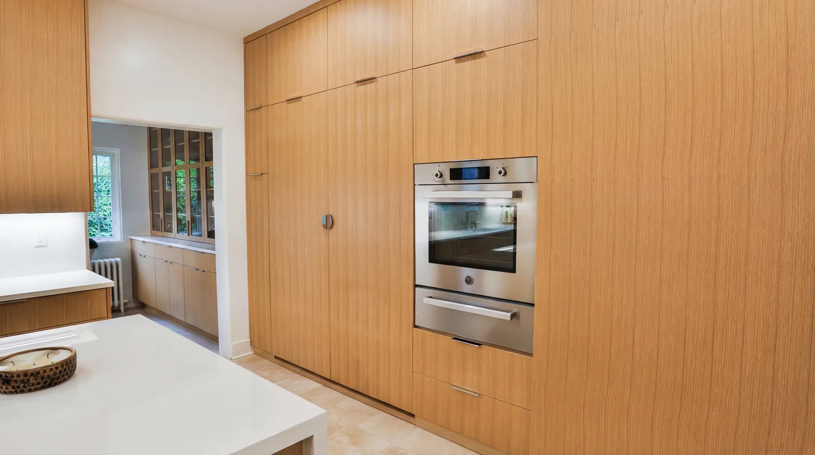 Bookmatched white oak cabinetry with a fully paneled Sub-Zero refrigerator