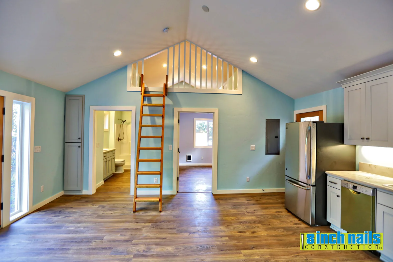 ADU great room with vaulted ceiling, sleeping loft and wood ship's ladder