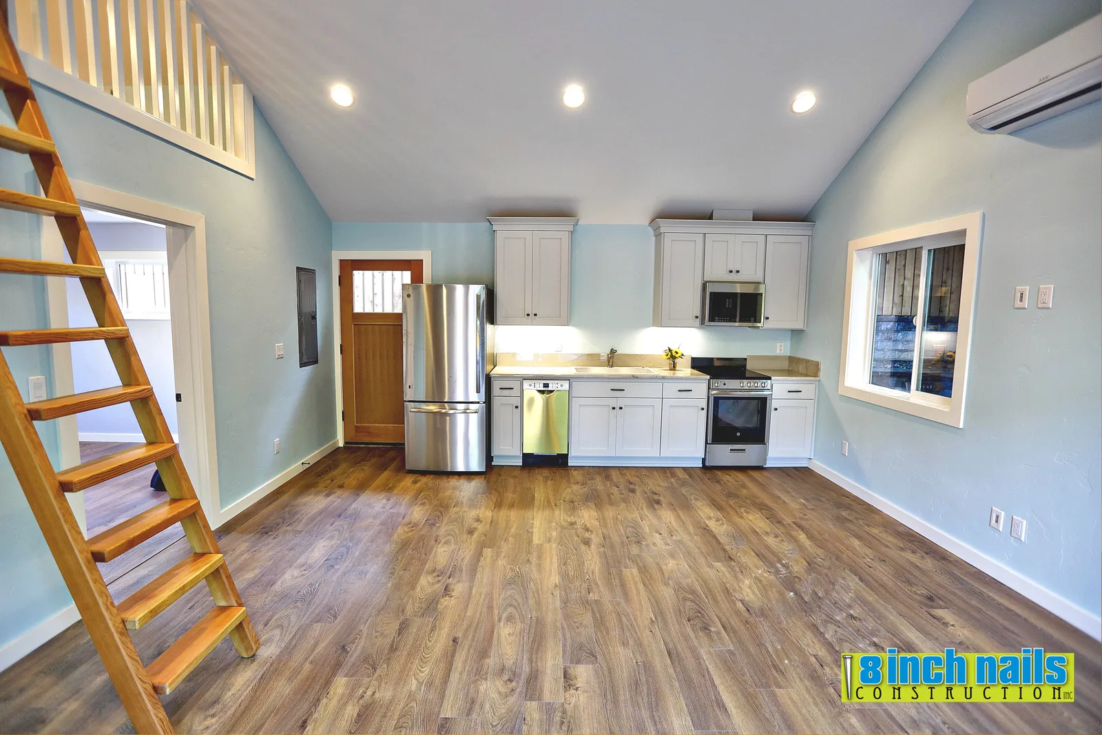 Open kitchen and living area beneath the sleeping loft in the Tigard ADU