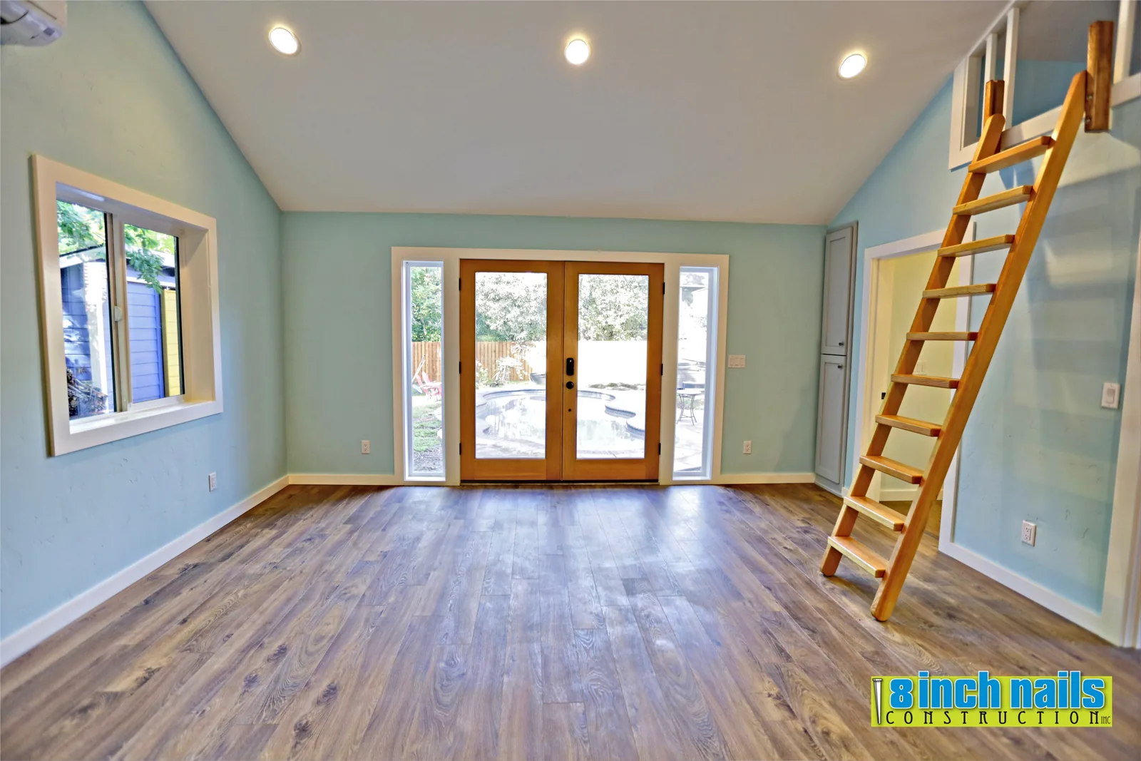 French doors with sidelites open the ADU living area onto the pool deck