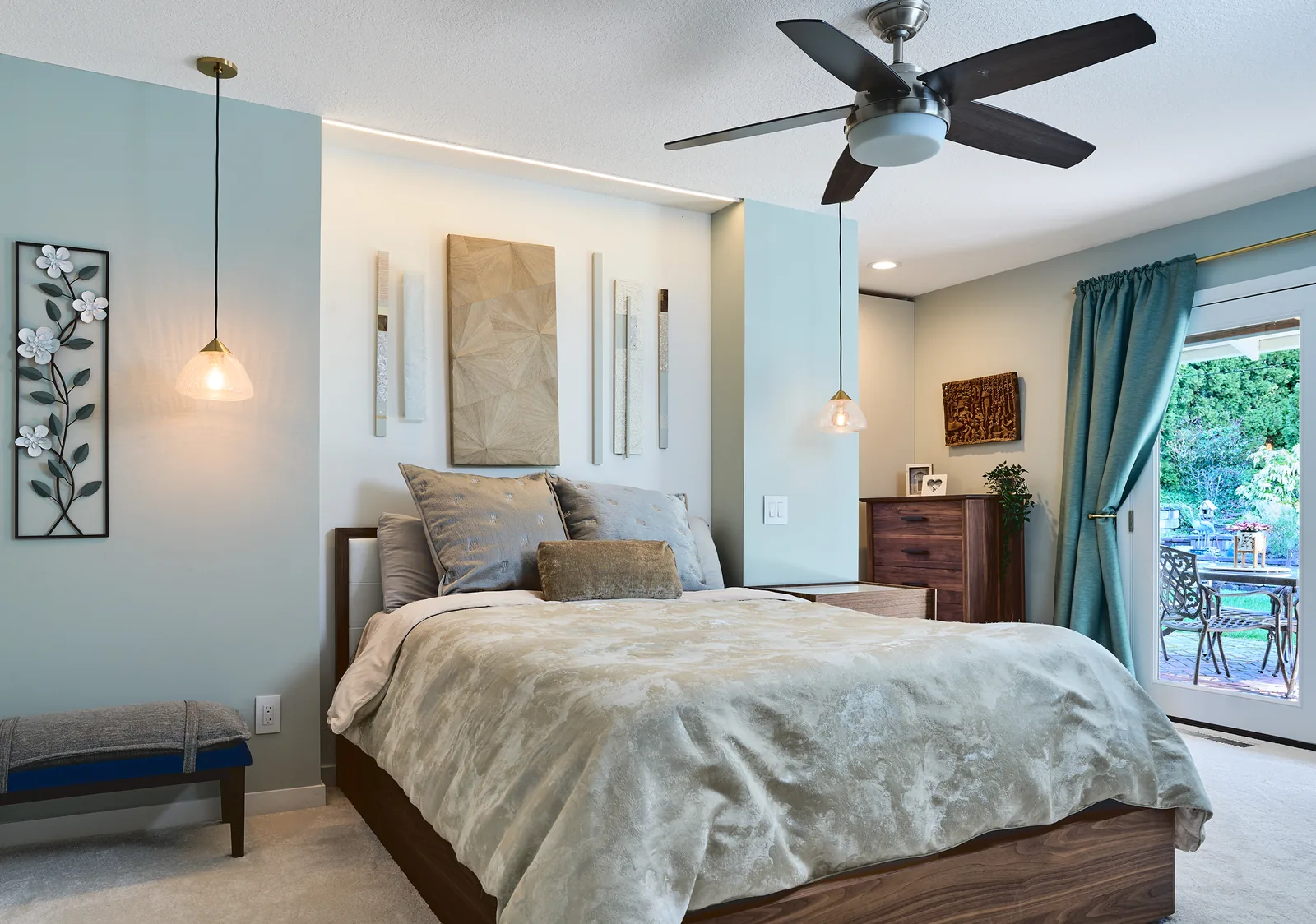 Primary bedroom with cove lighting above the bed and pendants either side