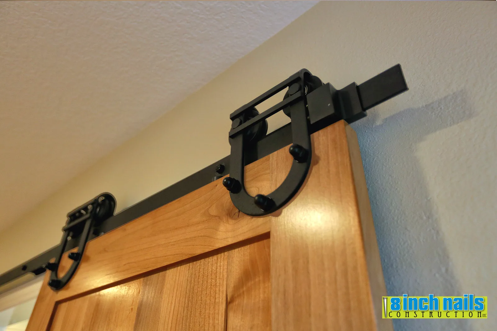 Sliding barn door on black horseshoe-strap hardware